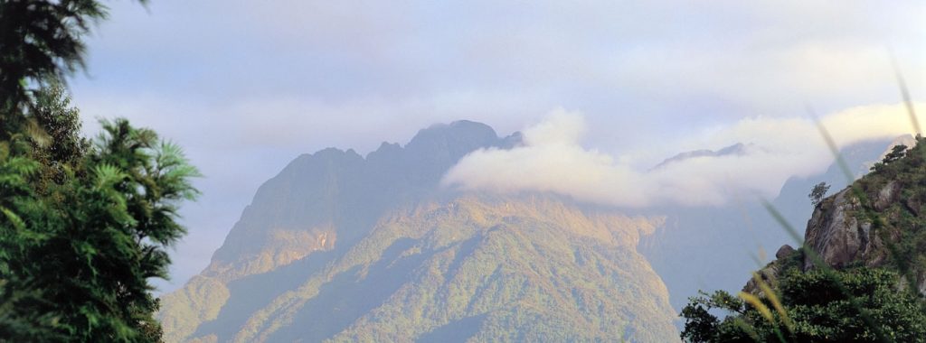 A distant view of the snow-capped Rwenzori mountains, one of the nearby attractions around Queen Elizabeth National Park