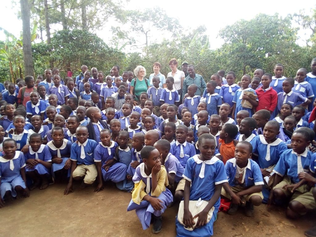 Pupils of Kichwamba Orphanage Foundation pause for a photo moment with some of their guests.